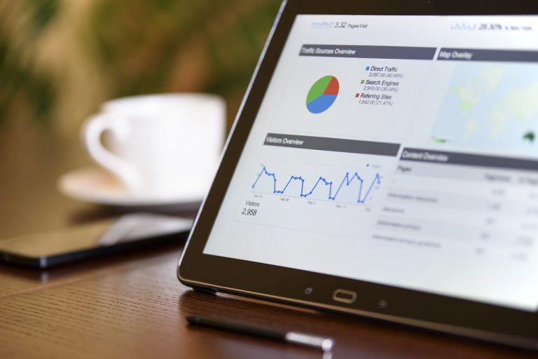 Ipad on a desk with charts and data displayed