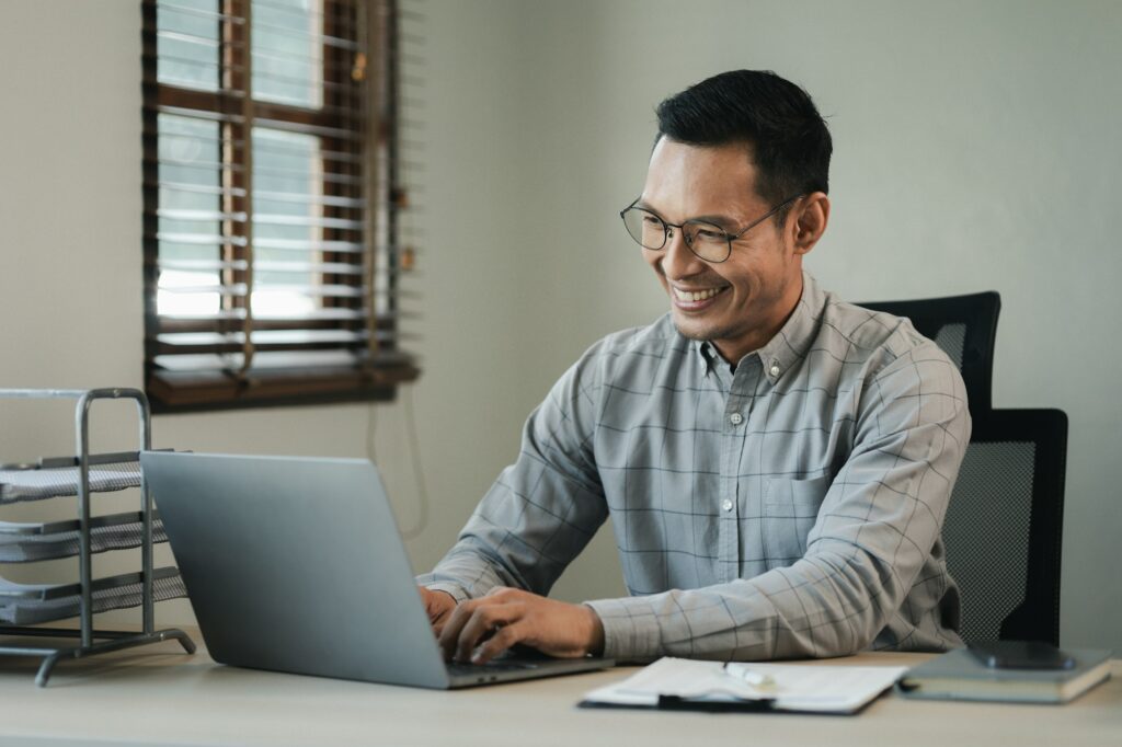 Businessman is sitting and working in the office, Employee is looking for information on laptop, An