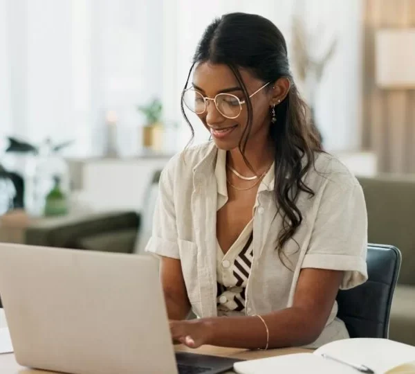 laptop-remote-work-and-woman-typing-for-research-in-the-living-room-of-modern-apartment-smile-te-1024x540